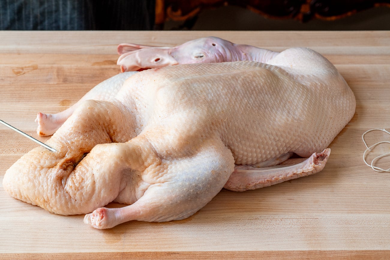 pekin duck with head on cutting board