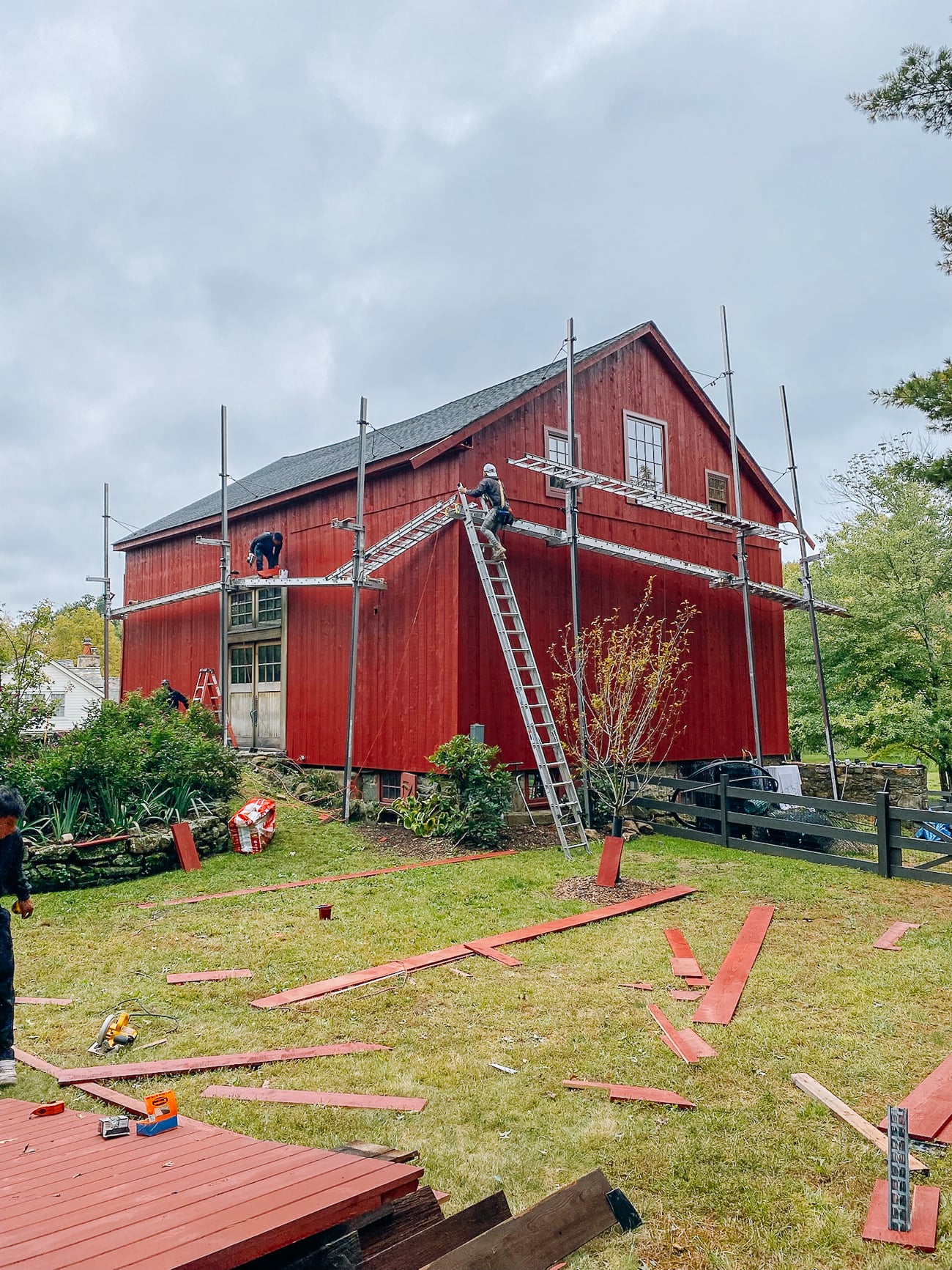 putting siding up on red barn