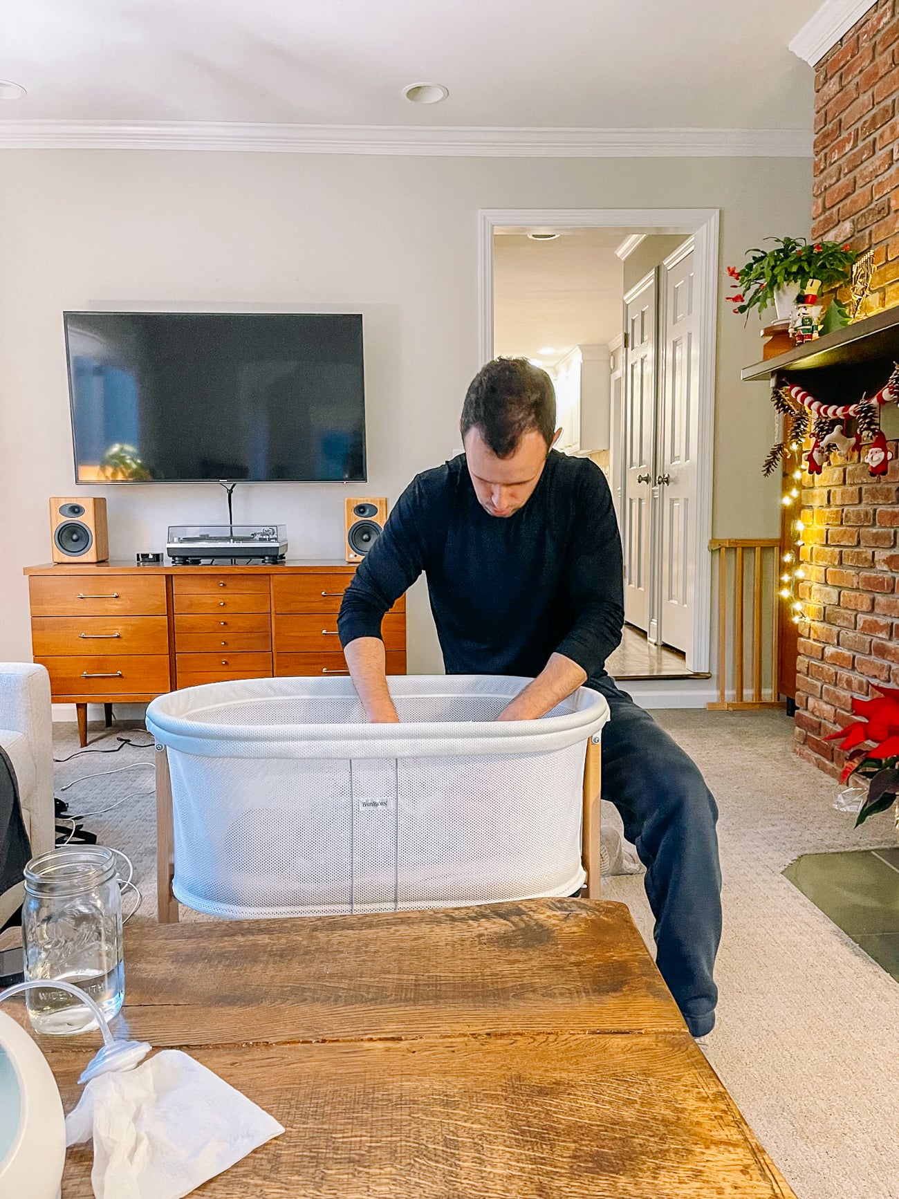 Justin with baby in bassinet
