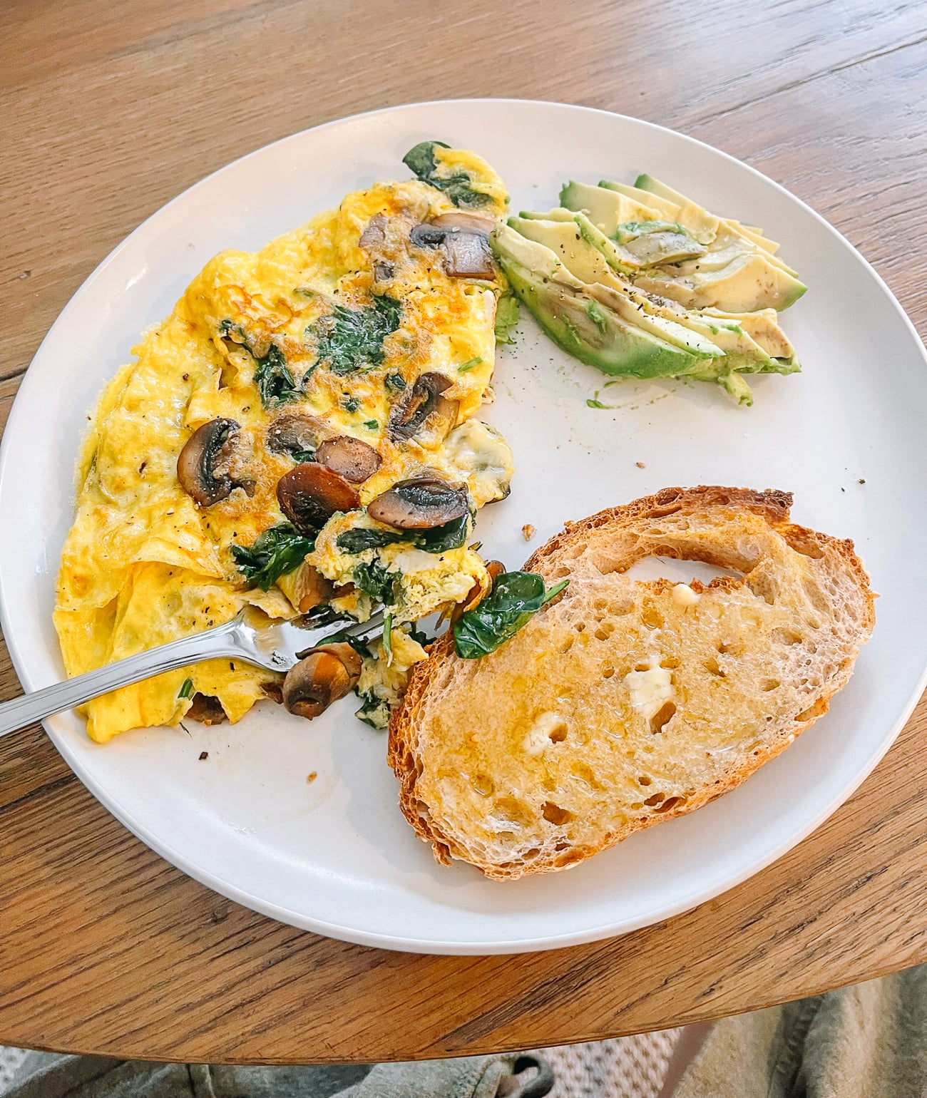 spinach mushroom omelet, avocado, and sourdough toast