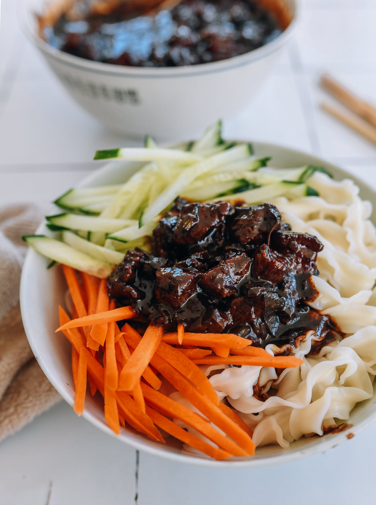 zha jiang mian with carrots, cucumber, and sauce