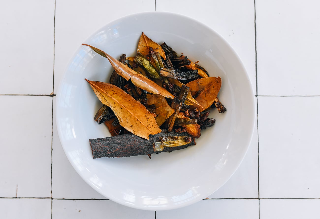 cooked aromatics in white bowl