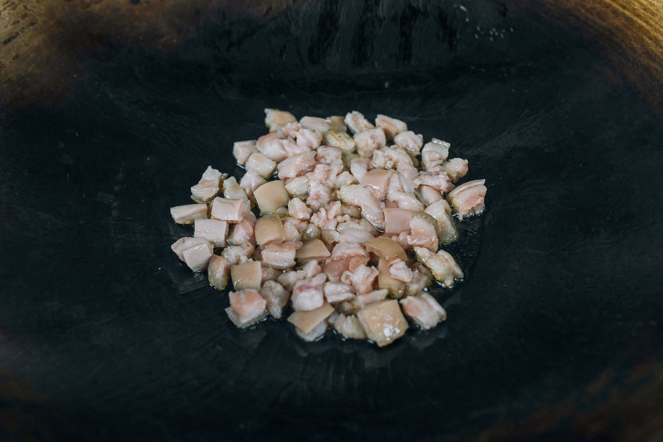 cooking pork pieces in wok