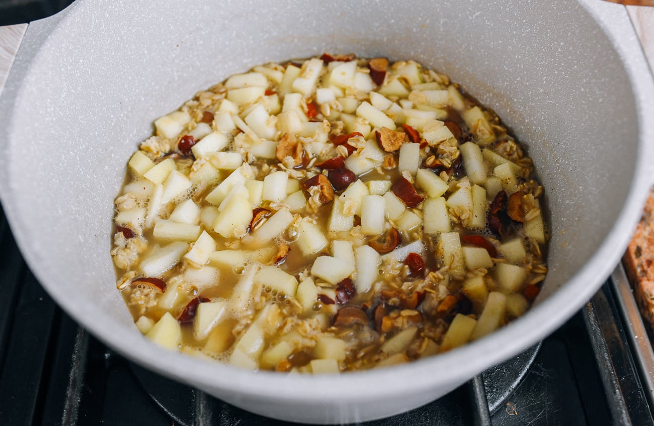 apples, oats, dates, goji berries, sugar, water in pot