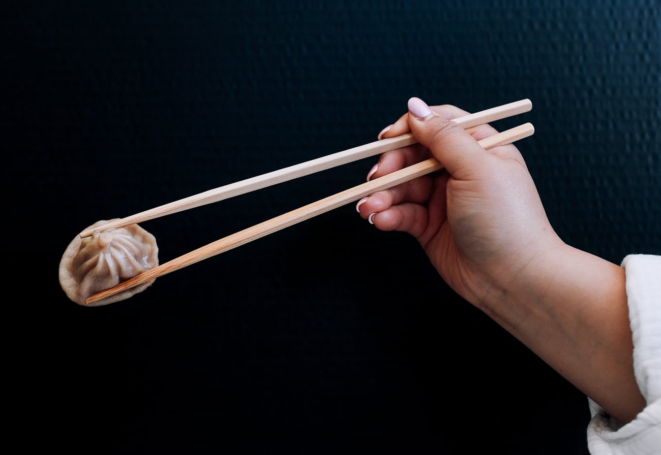 picking up dumpling with chopsticks