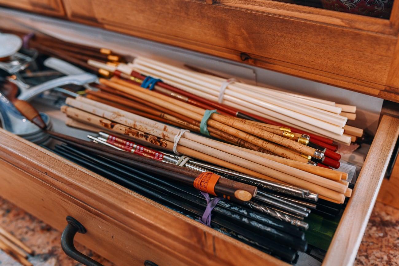 bunches of chopsticks tied with rubber bands in drawer