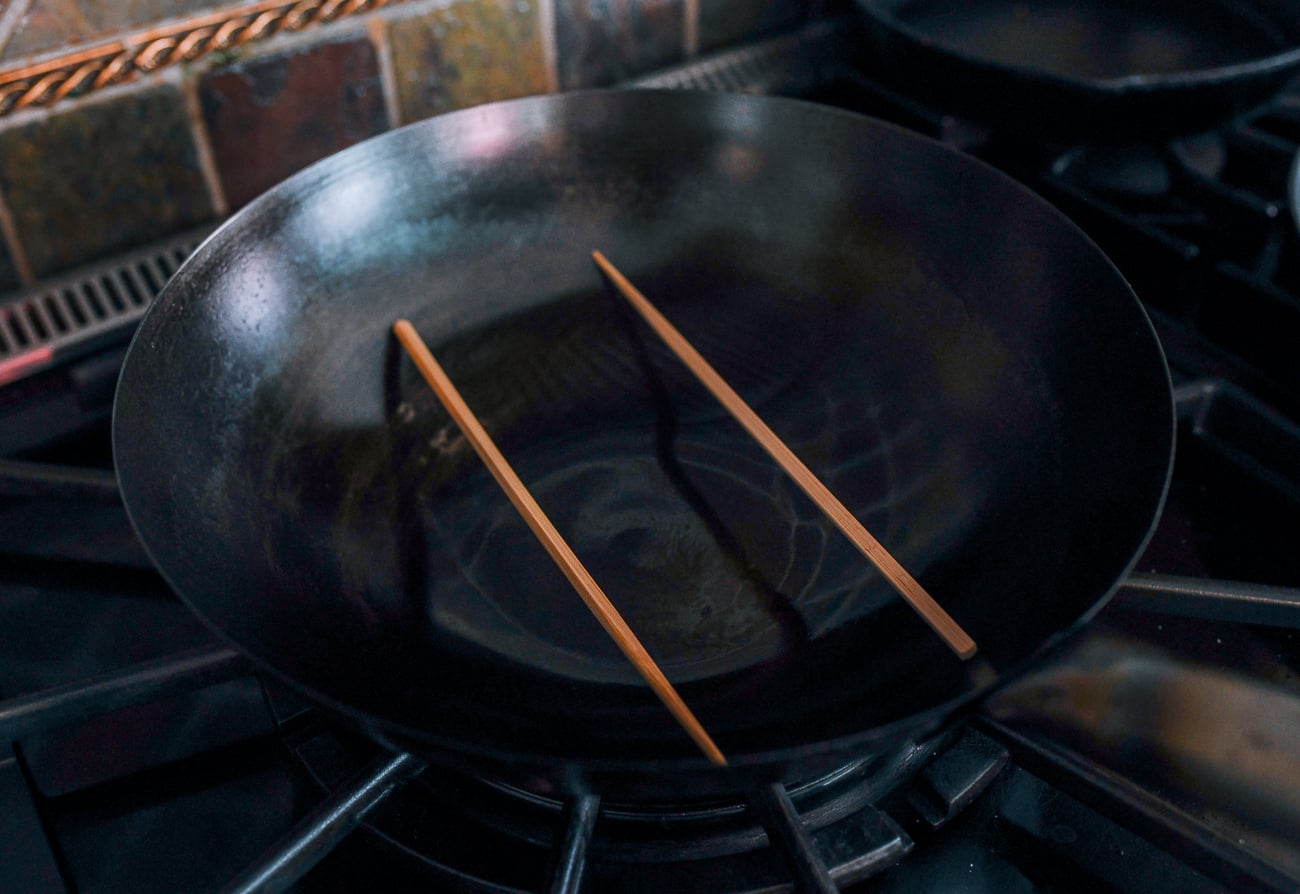 chopsticks in wok with water for steaming