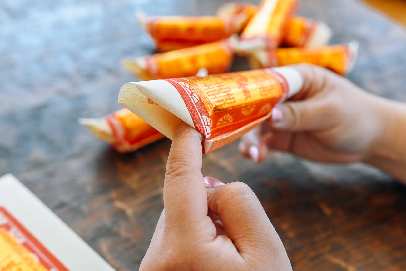 tucking ends of joss paper to make gold bar