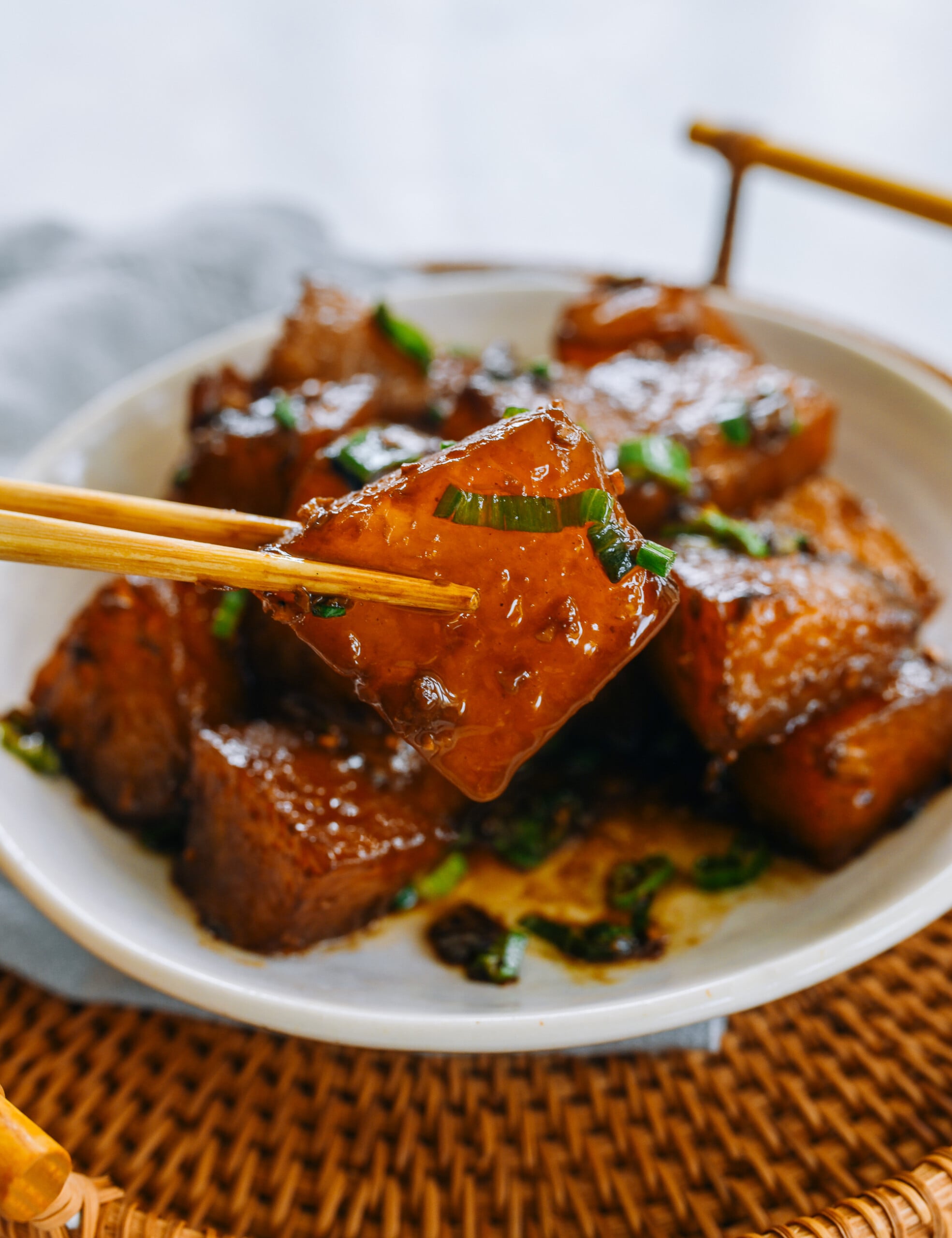 PIcking up piece of braised winter melon with chopsticks