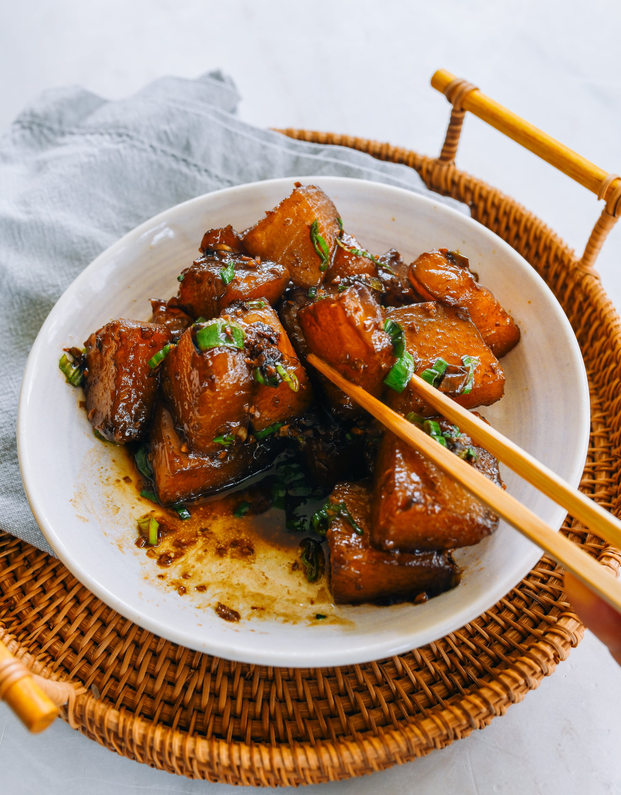 PIcking up piece of braised winter melon with chopsticks
