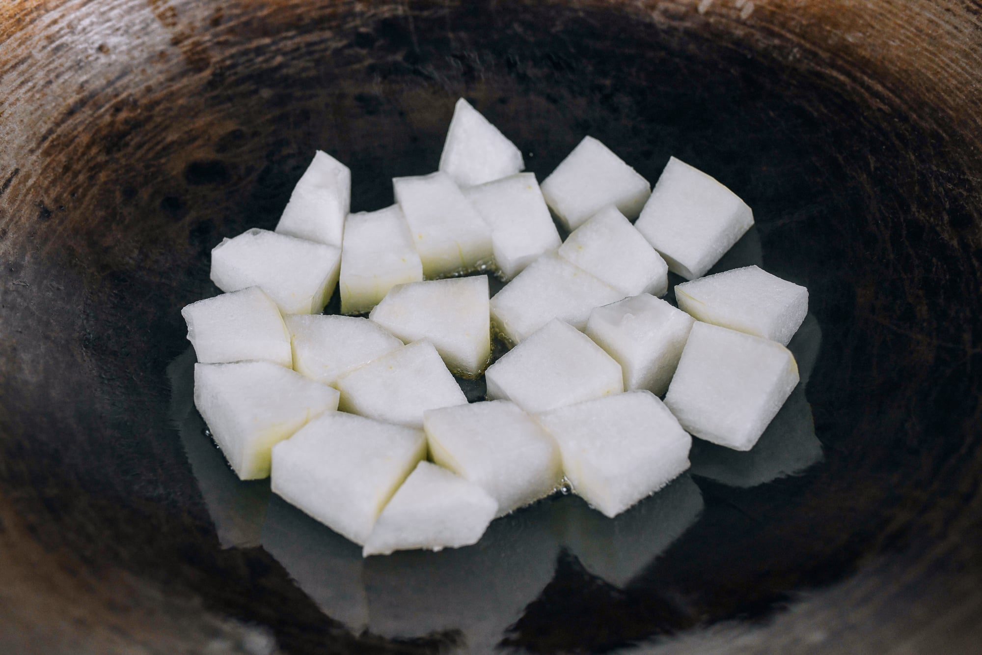 winter melon pieces cooking in wok