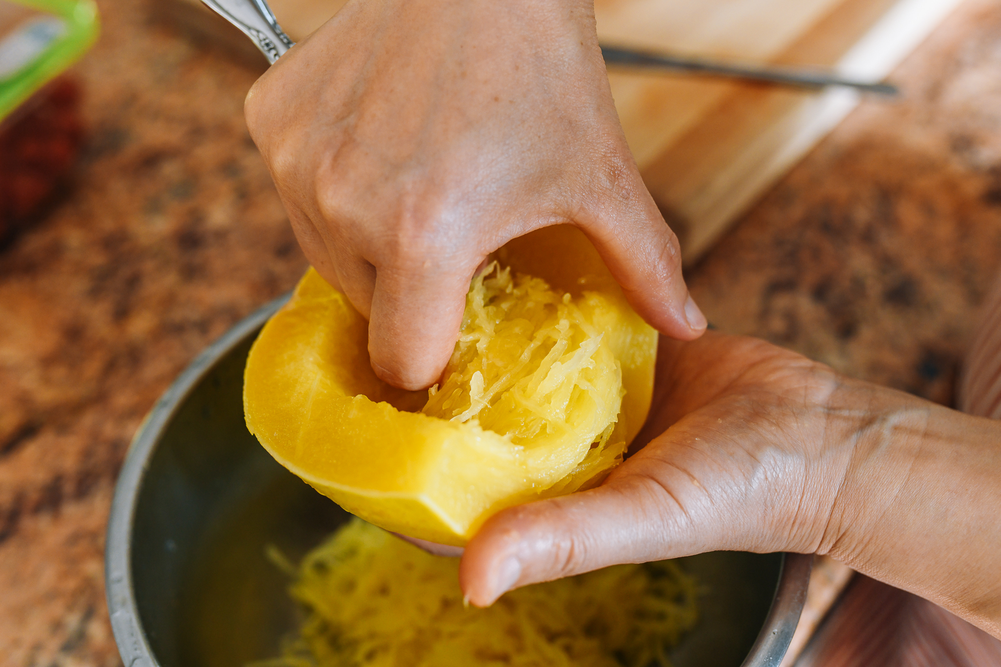 scooping steamed spaghetti squash out