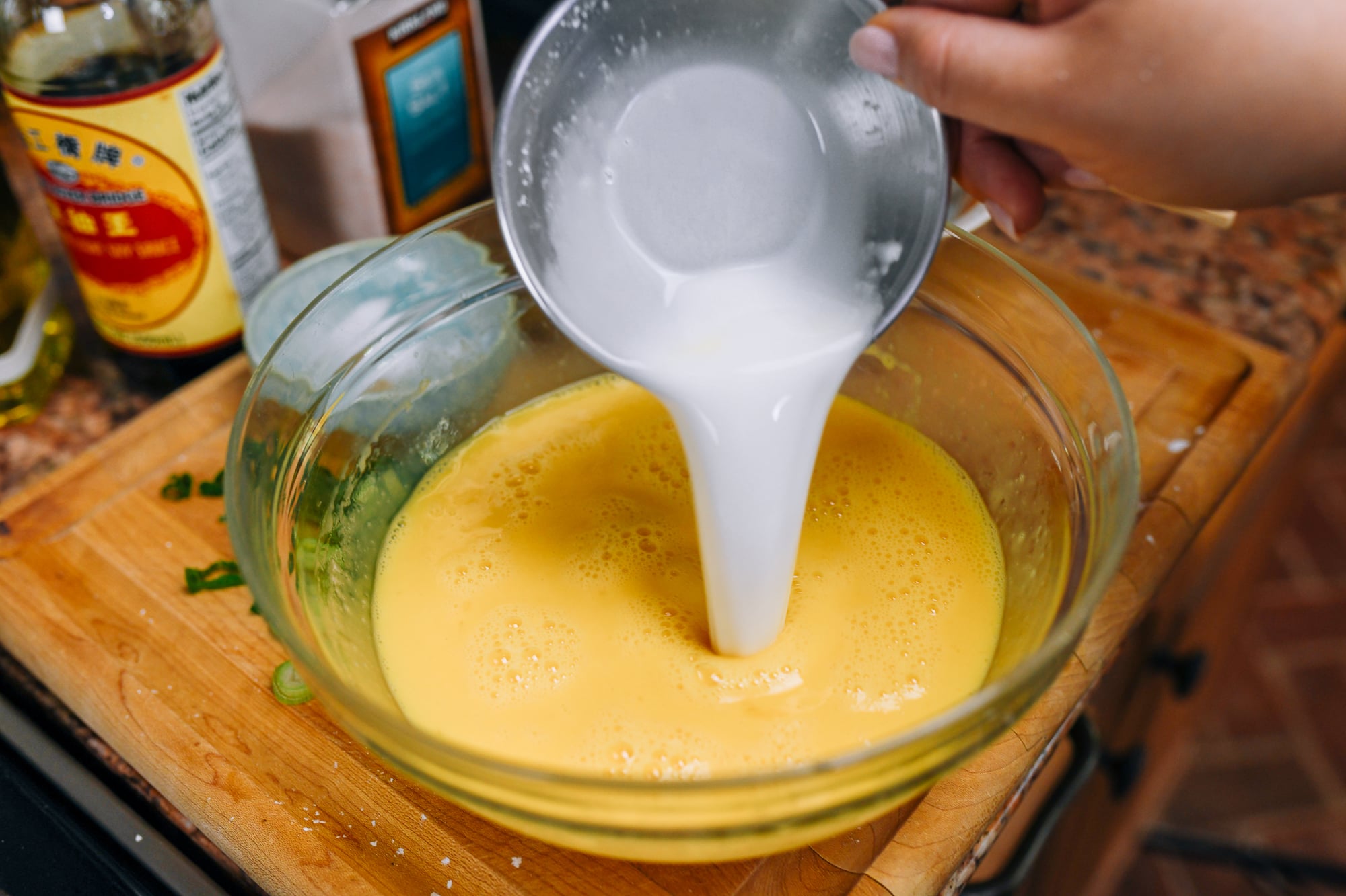 pouring cornstarch slurry into beaten egg