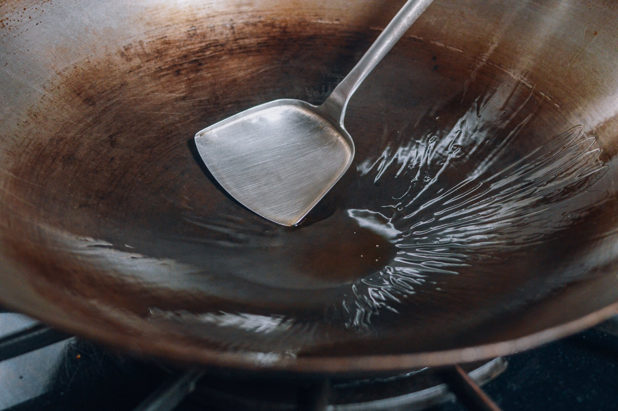 oiled wok with wok spatula