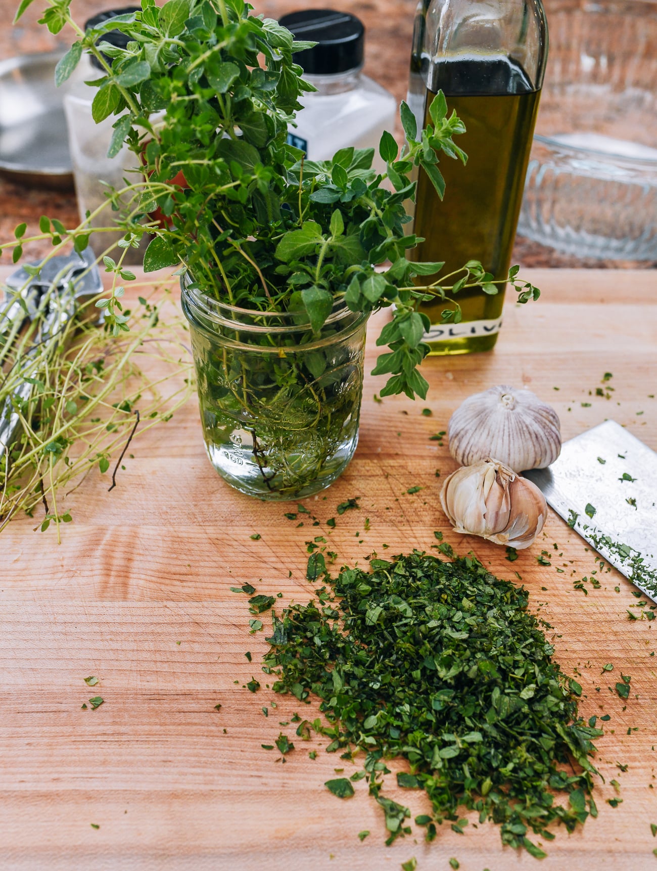 chopping herbs and garlic for chicken marinade
