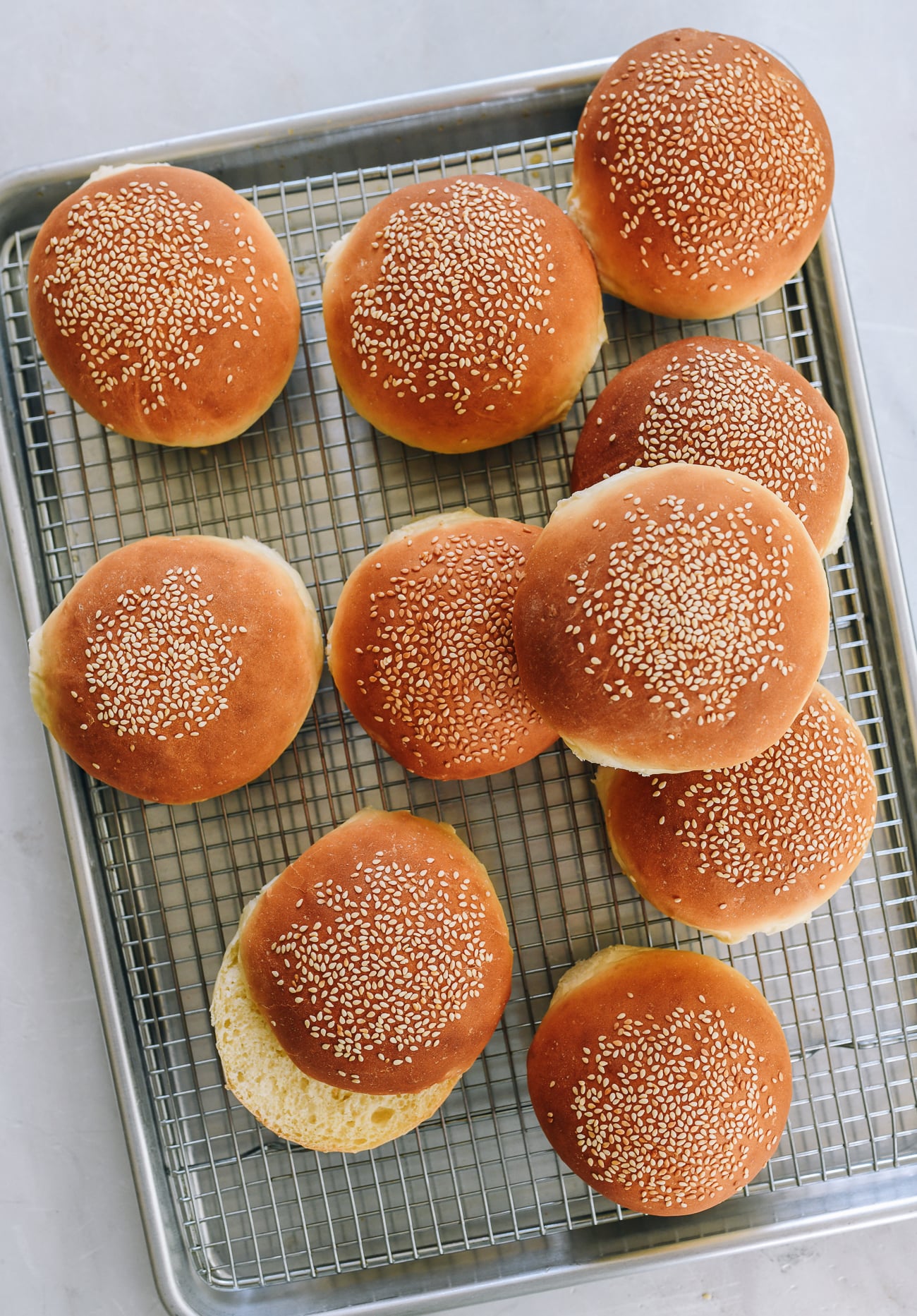Ten hamburger buns on cooling rack