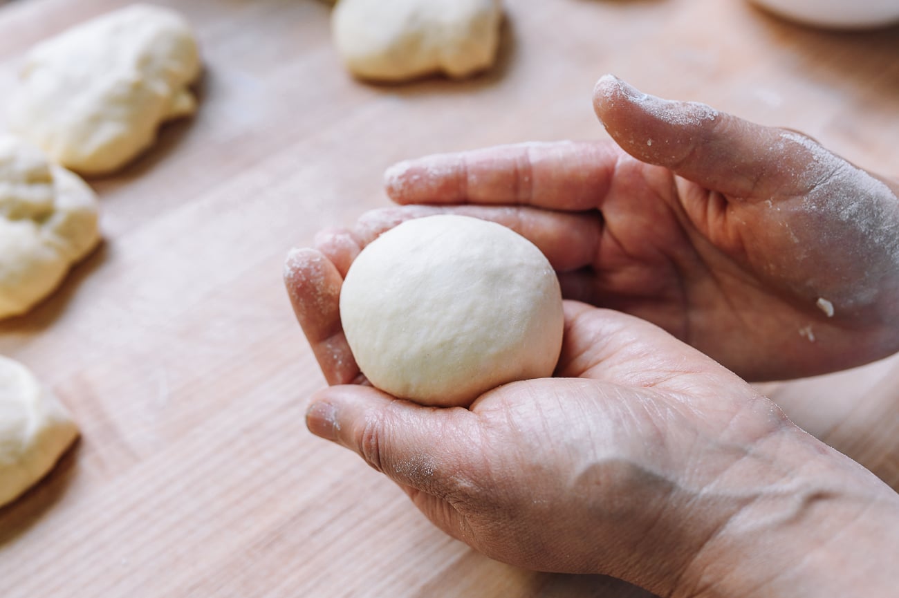 holding ball of dough in palm of hand