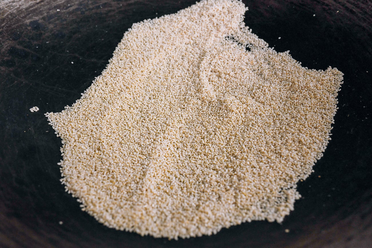 sesame seeds toasting in wok