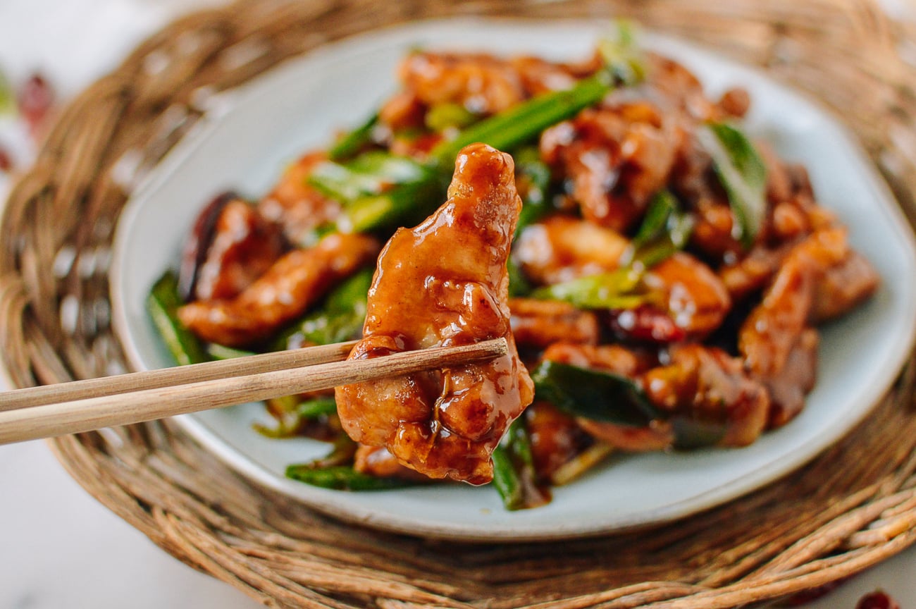 picking up piece of crispy saucy mongolian chicken with chopsticks