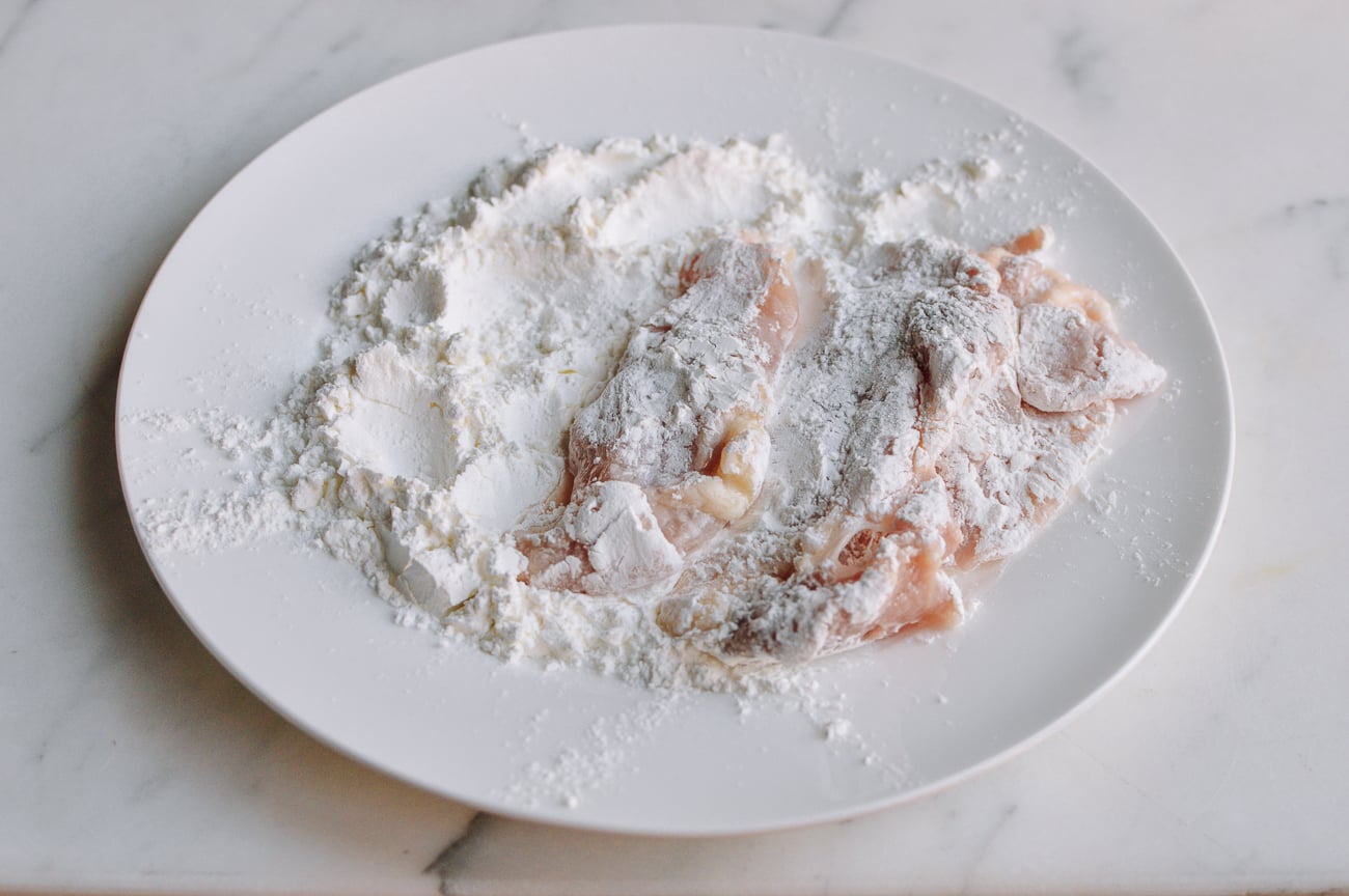 dredging chicken pieces in cornstarch