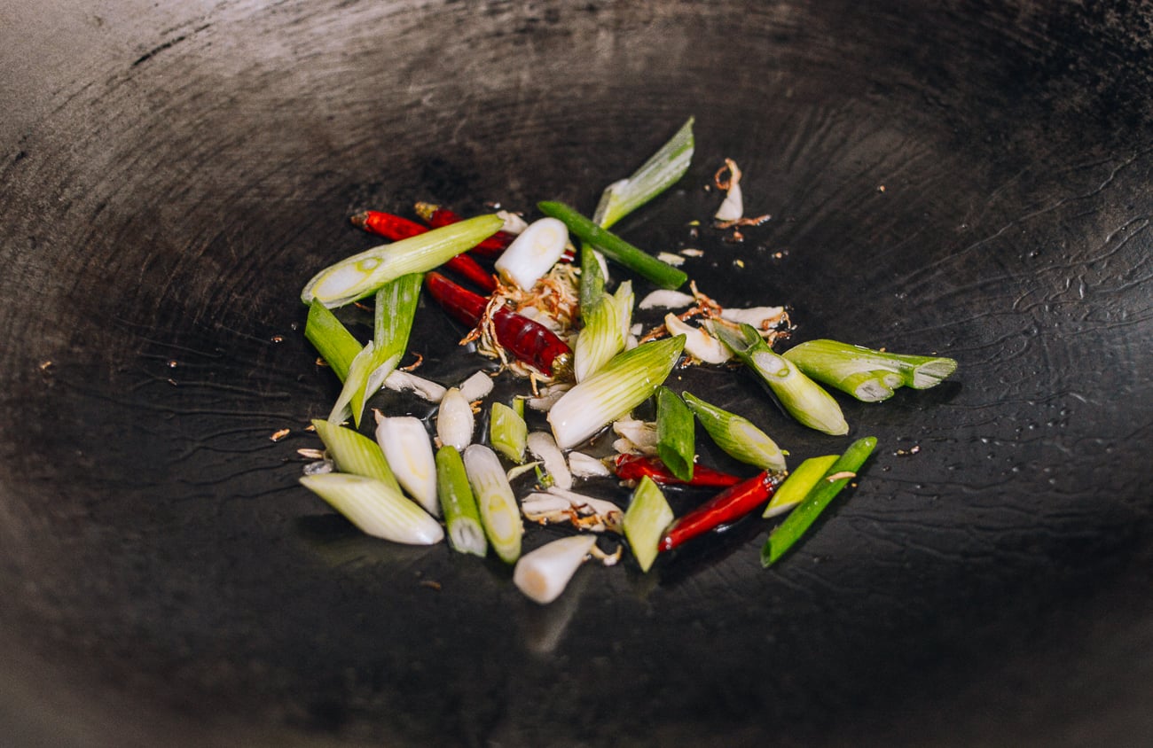 scallion whites and aromatics in wok