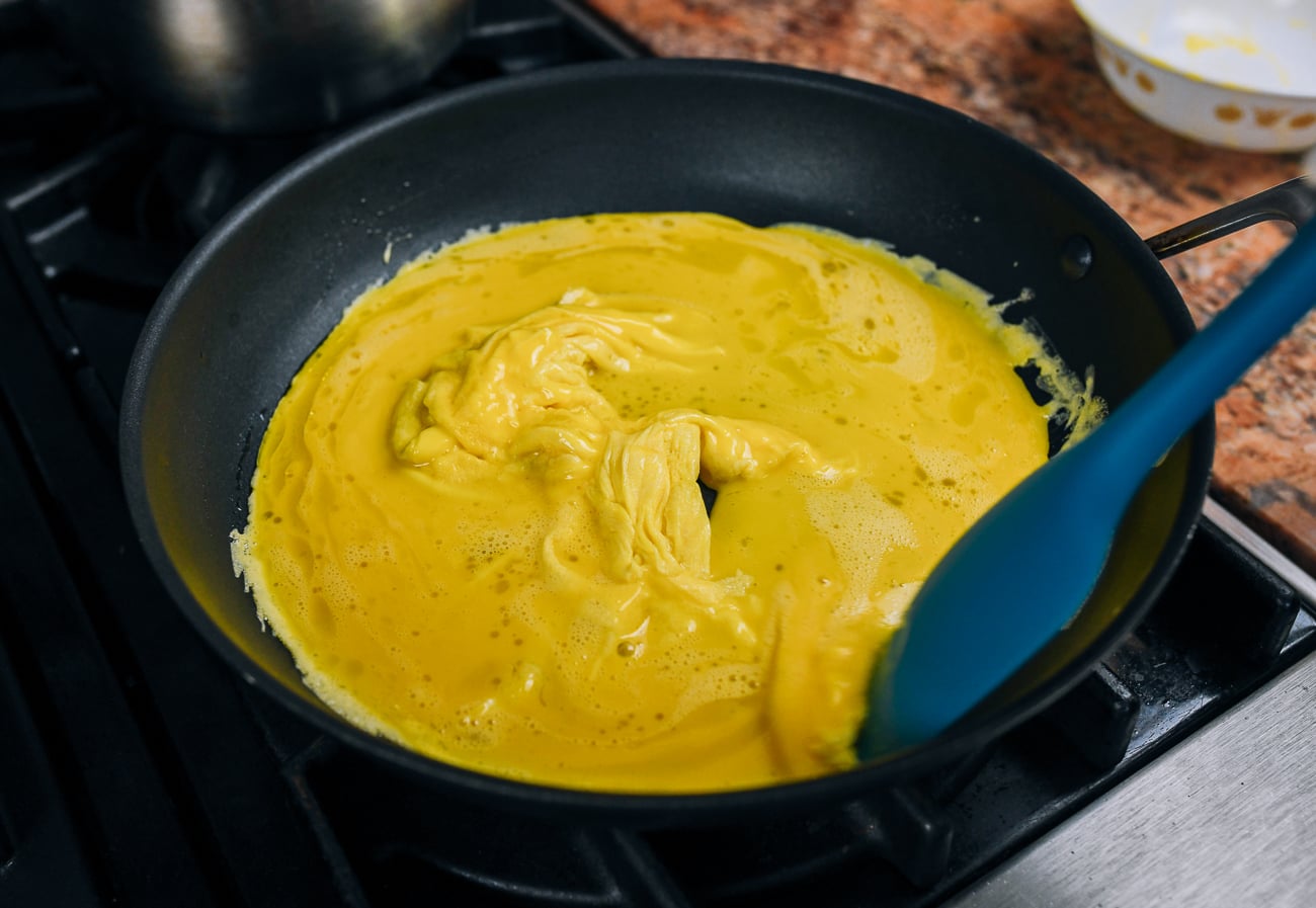 cooking scrambled eggs in nonstick skillet with stiff rubber spatula