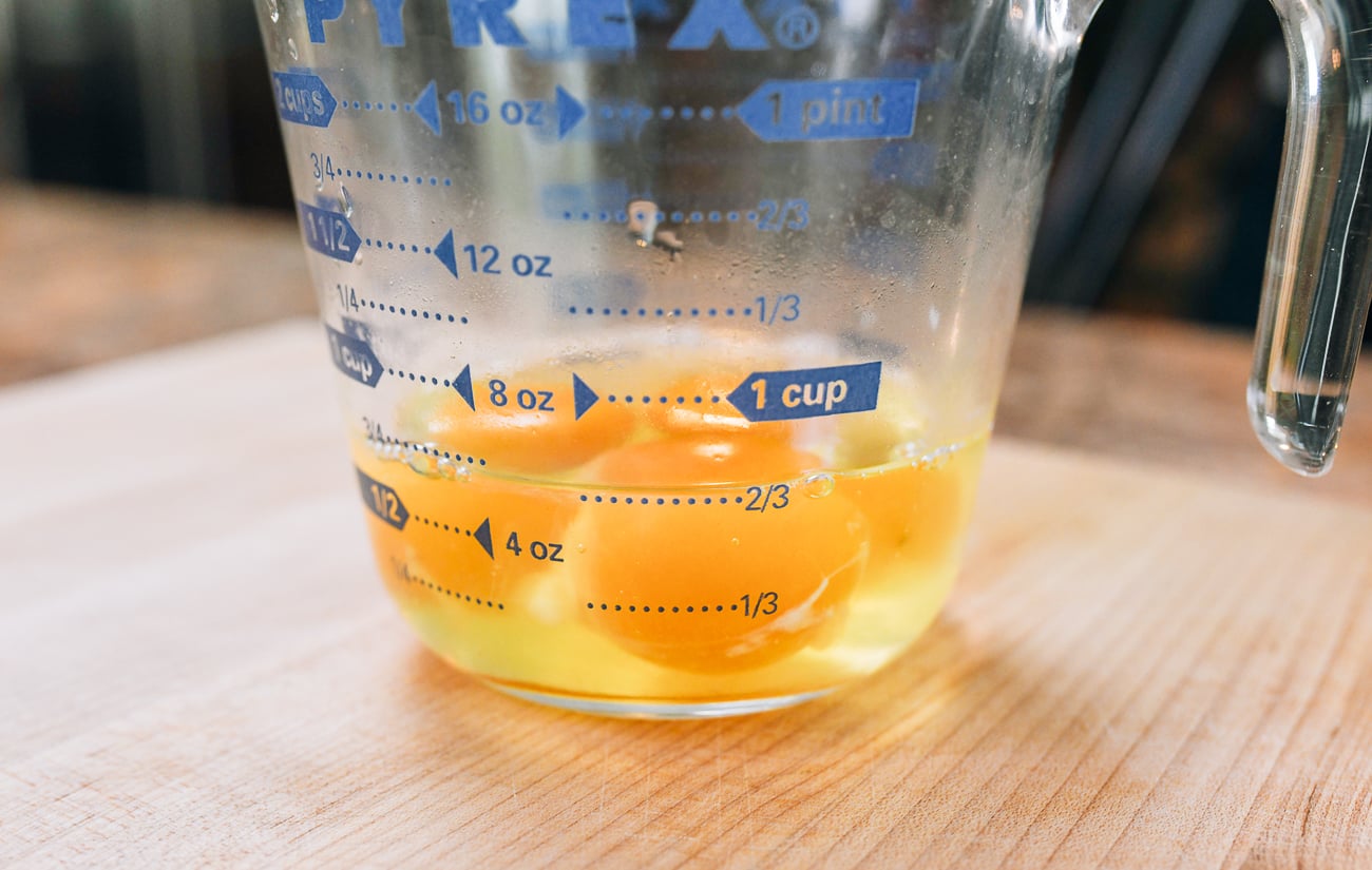 3 eggs cracked into measuring cup