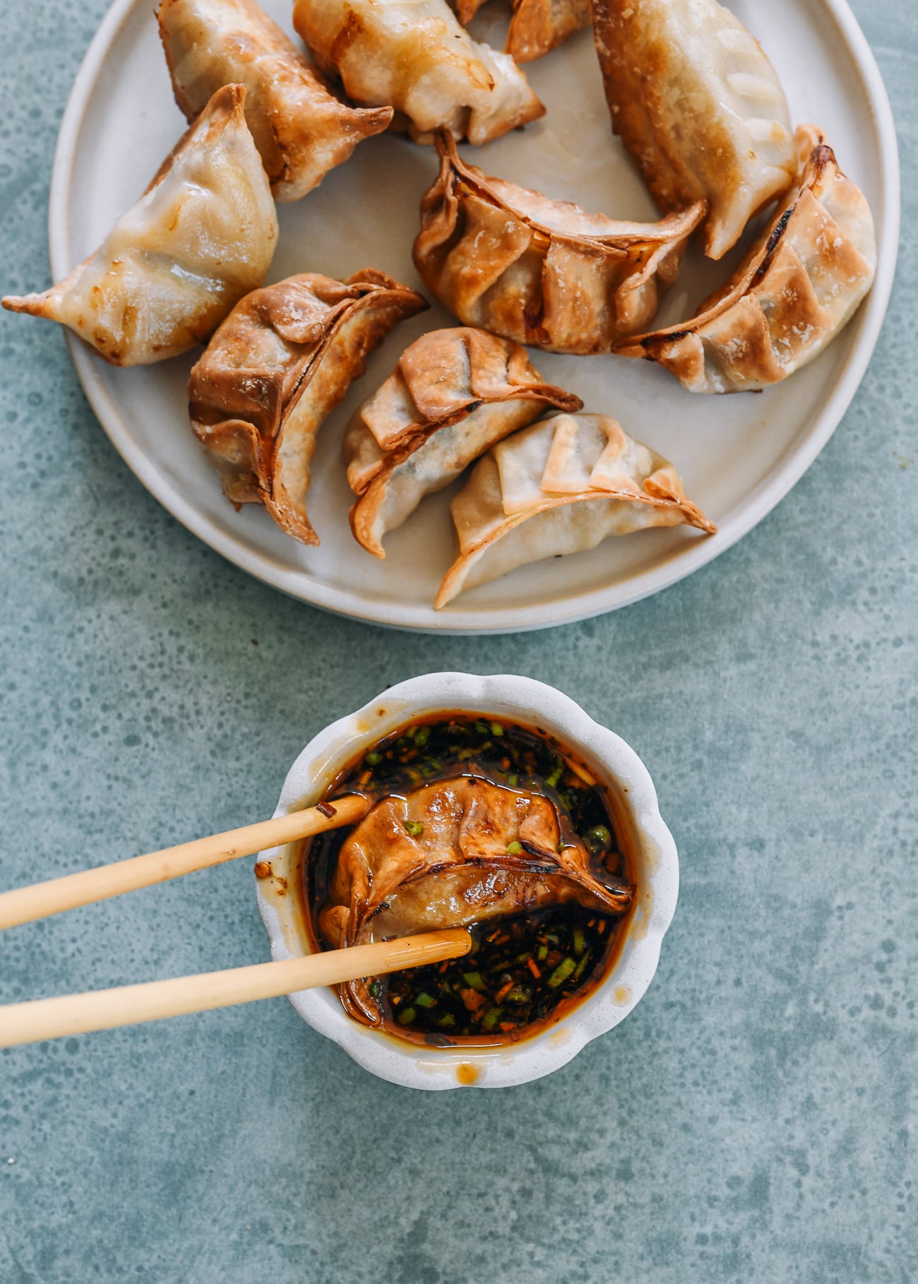 dipping air fryer dumpling into sauce