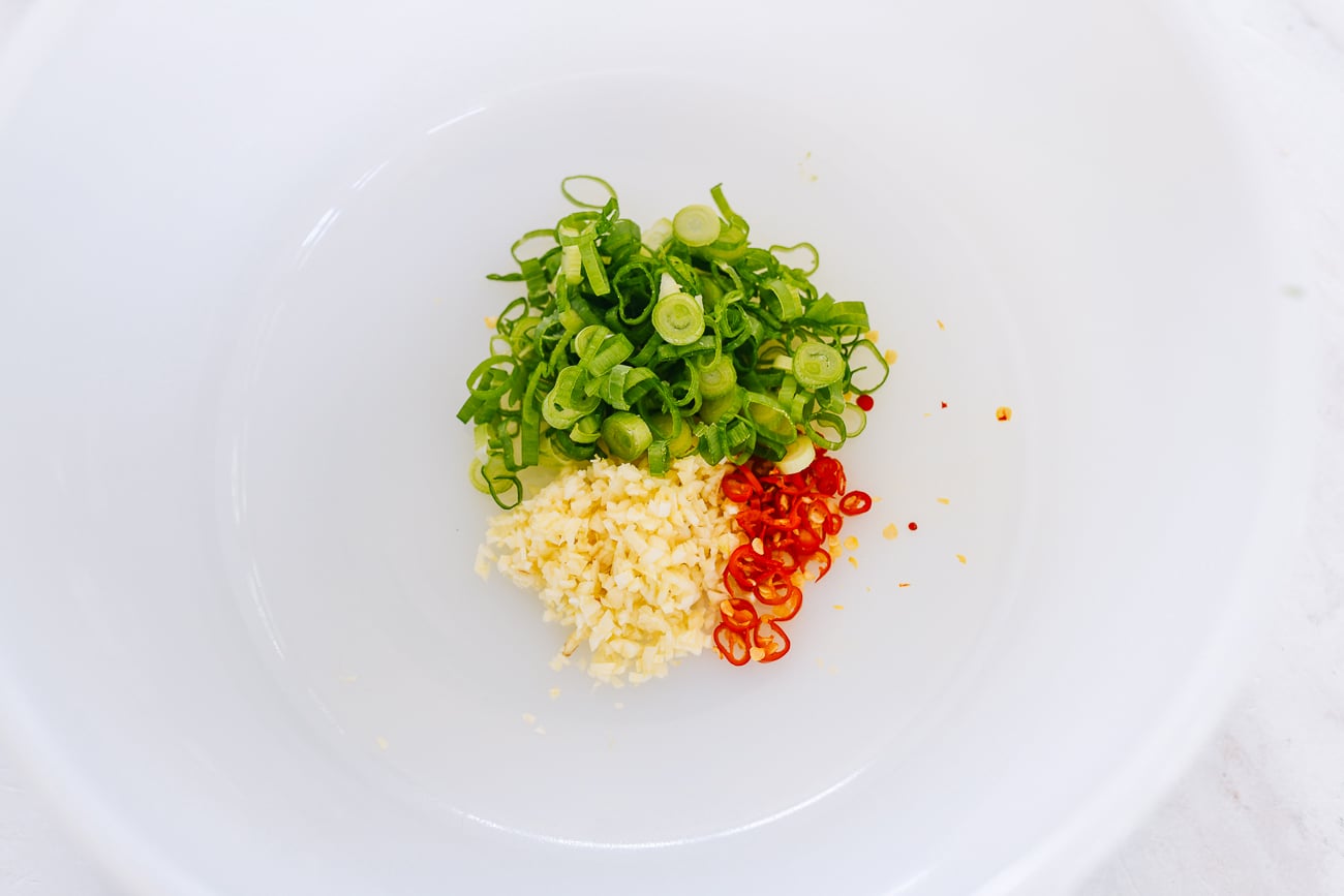 chopped scallion, garlic, and chili in heatproof bowl