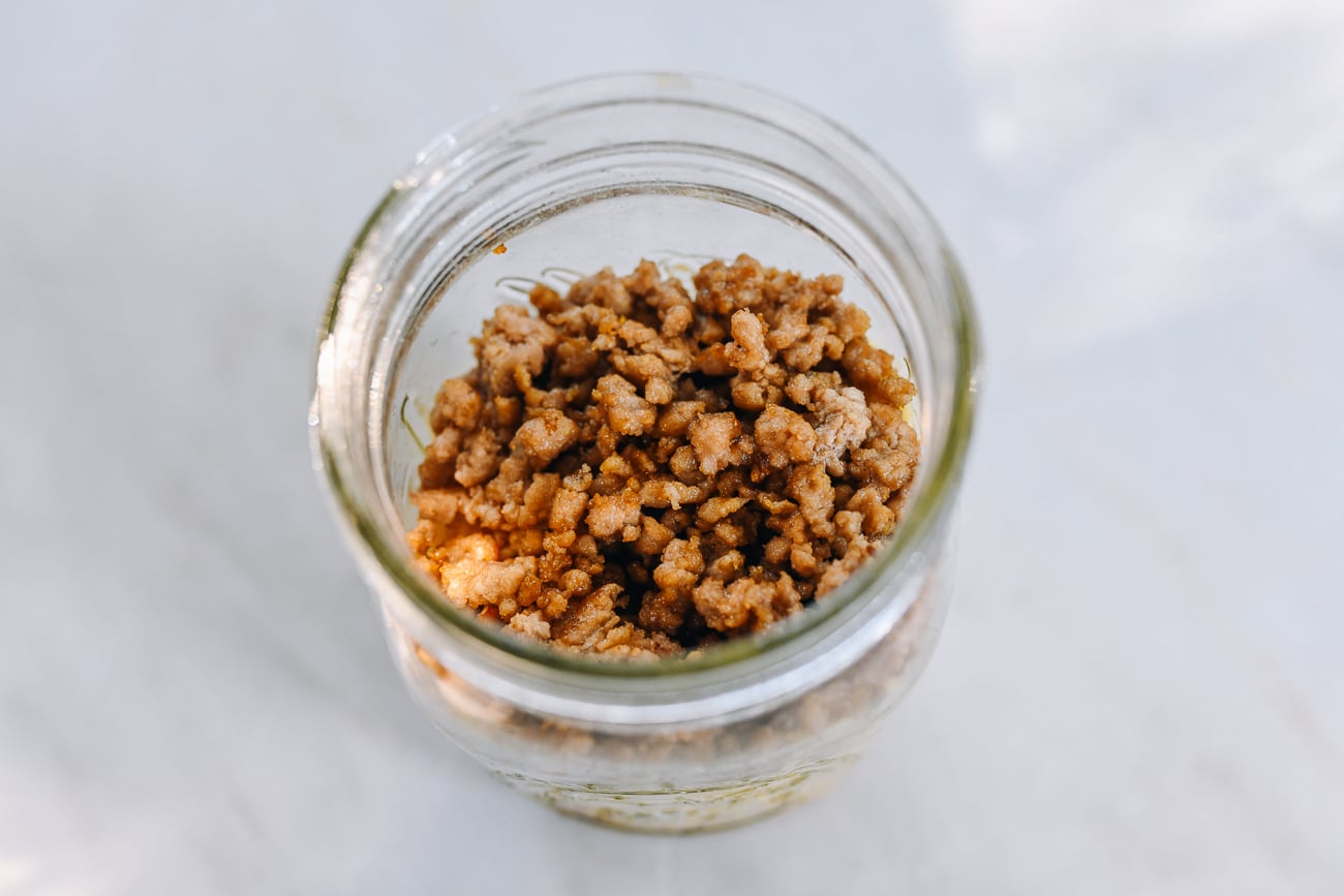 ground pork on top of noodles in jar