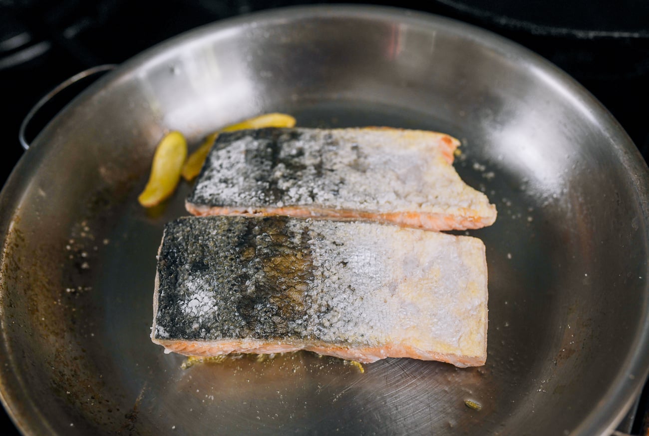 searing salmon fillets in stainless steel frying pan