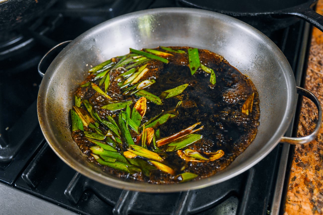 soy sauce, shaoxing wine wine, black vinegar, sugar, scallions, and ginger in pan