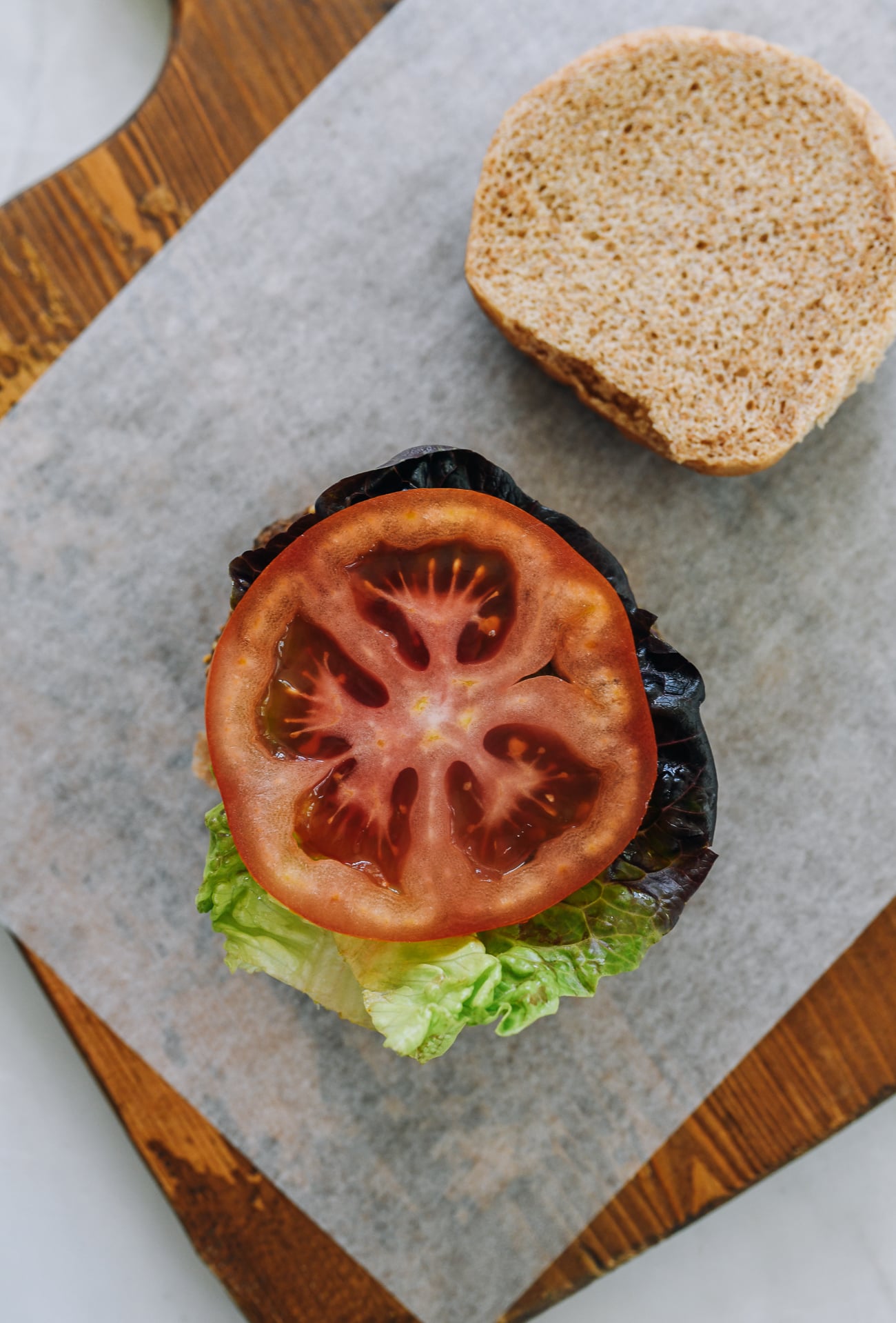 burger with lettuce and tomato on top