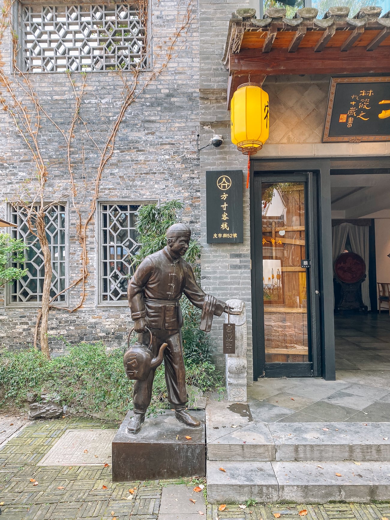 Statue of man serving tea