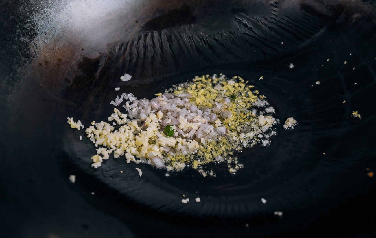ginger, garlic and shallots cooking in wok