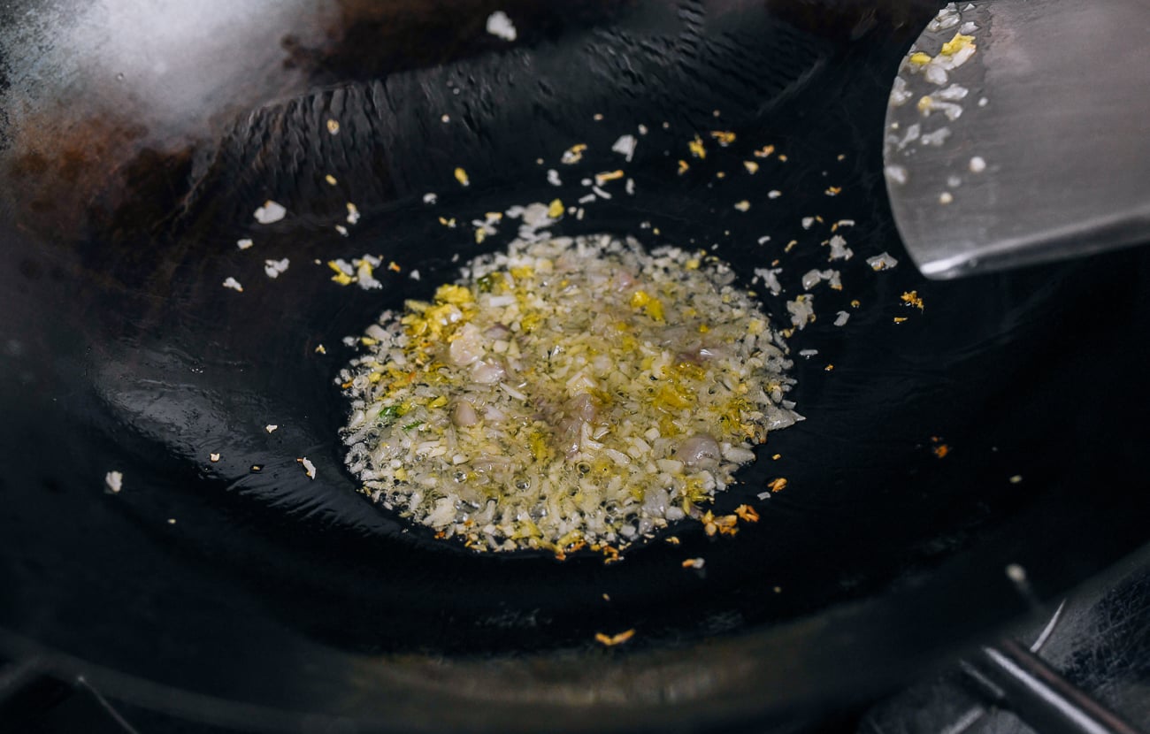 cooking ginger, garlic, and shallots in wok