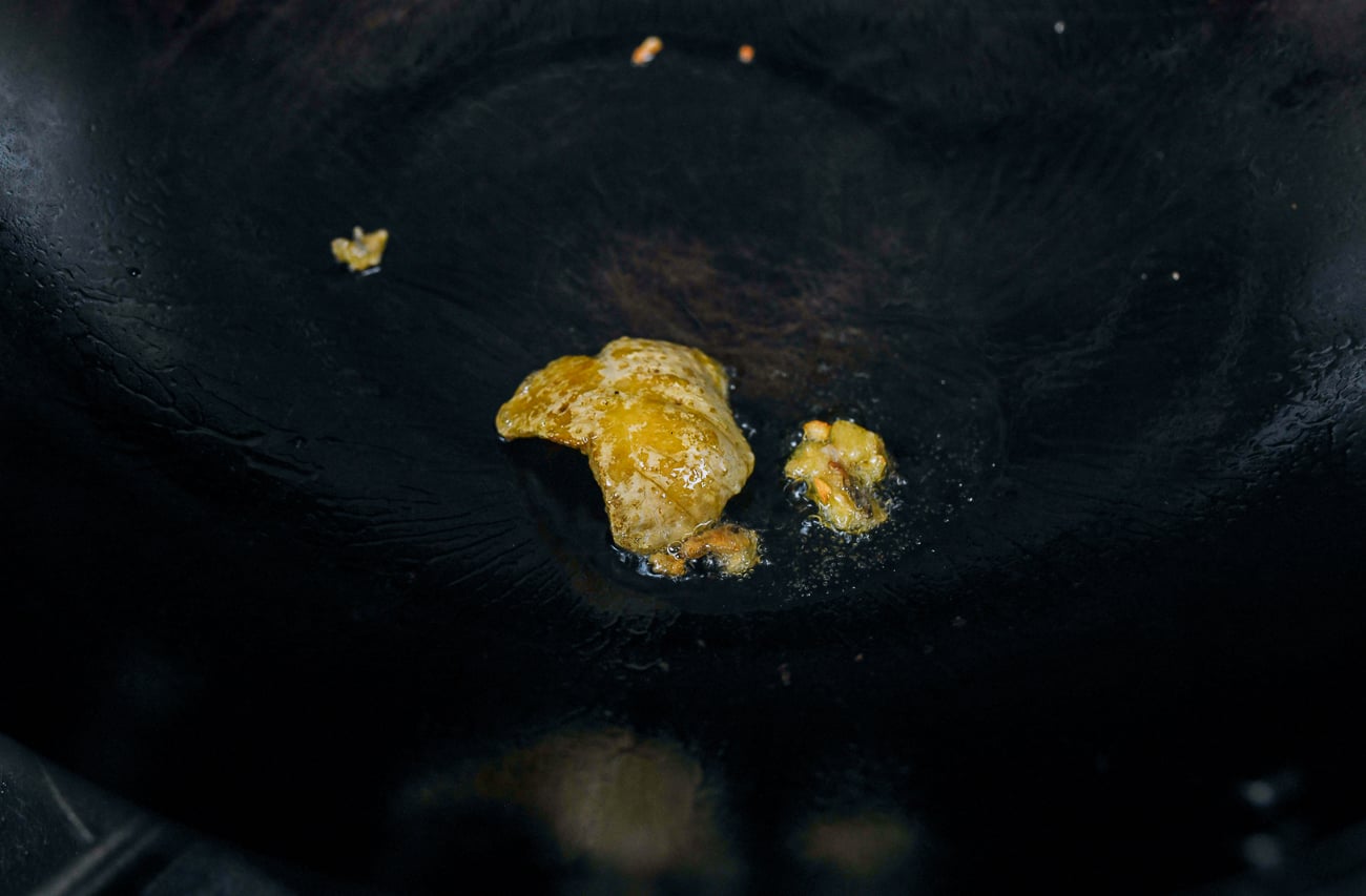 rendering chicken fat in wok