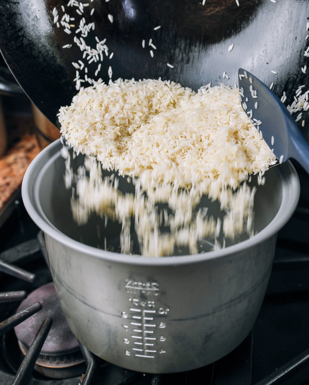 pouring rice into rice cooker