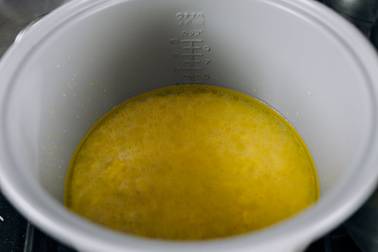 rice with chicken stock in pot