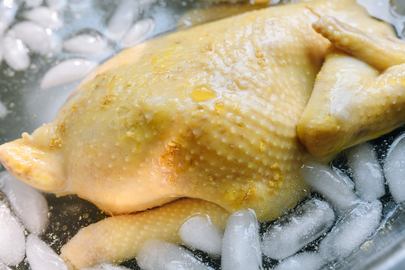 poached hainan chicken in ice bath