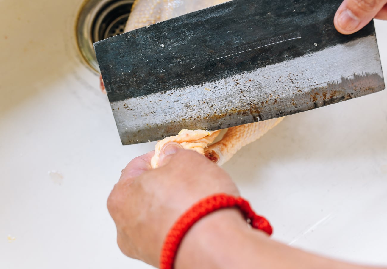 trimming chicken fat from cavity 