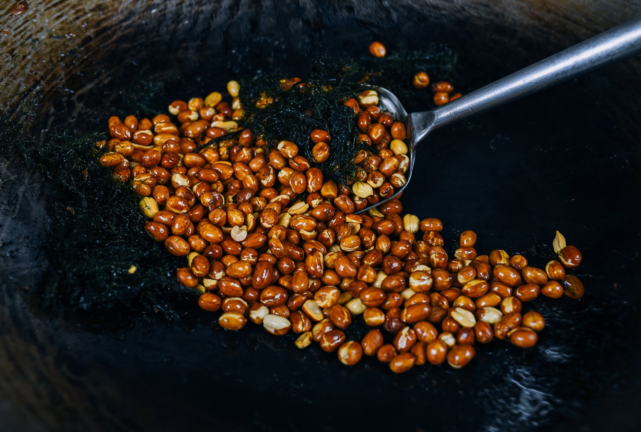 stirring roasted peanuts with seaweed in wok