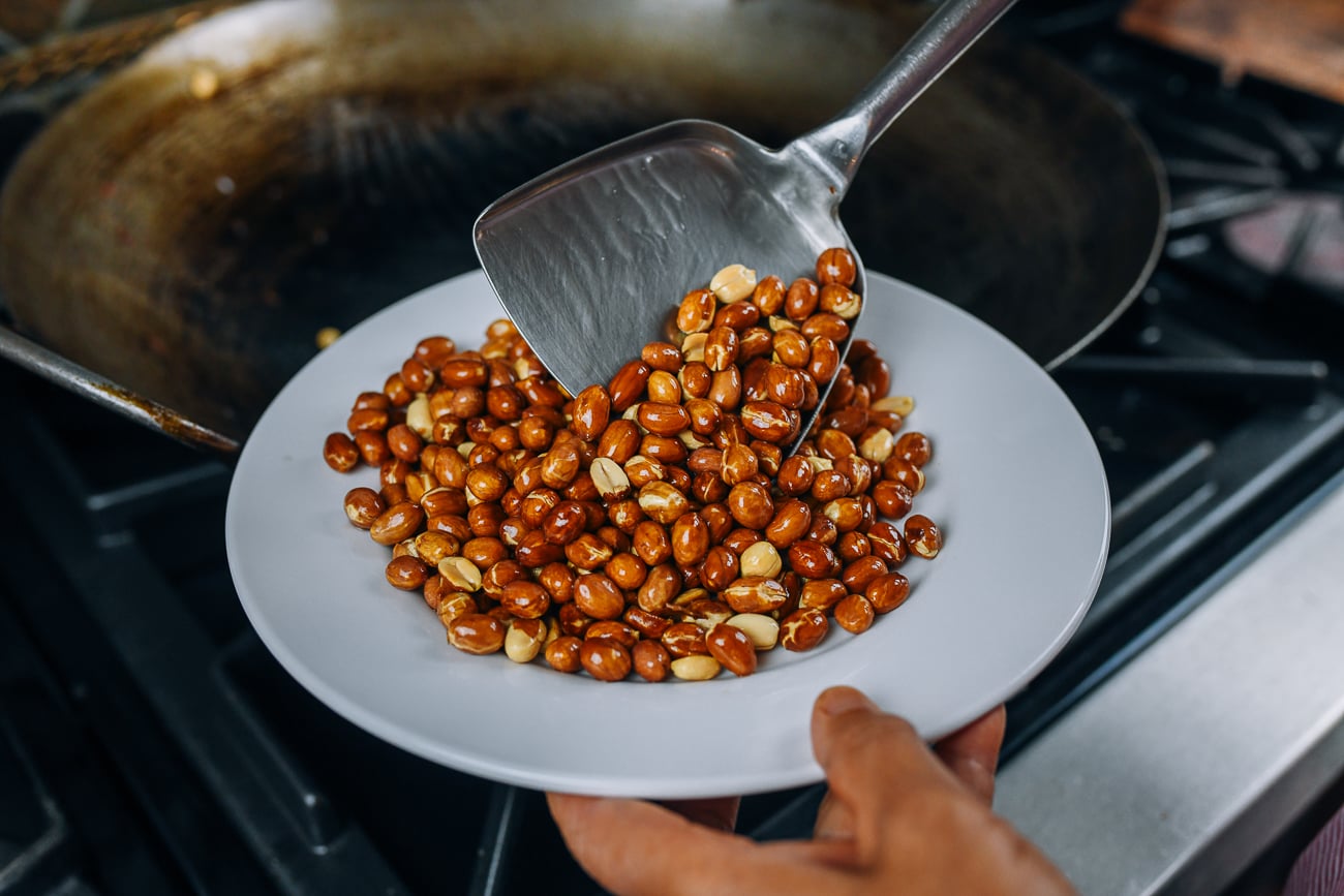 removing roasted peanuts from wok