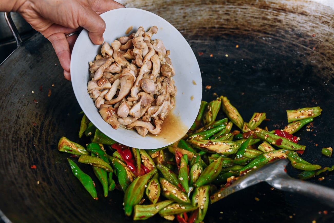 adding chicken back to wok with okra