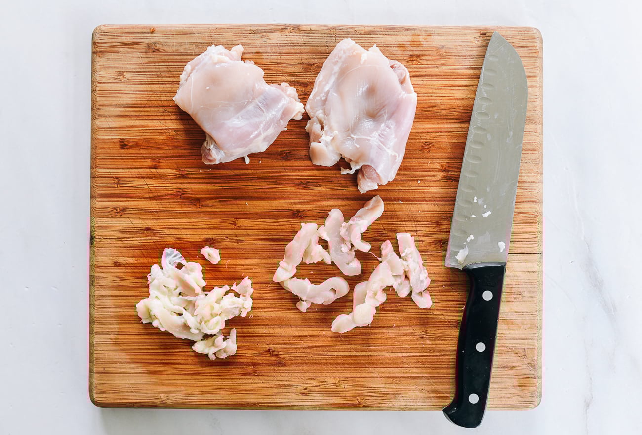 slicing boneless skinless chicken thighs into thin strips