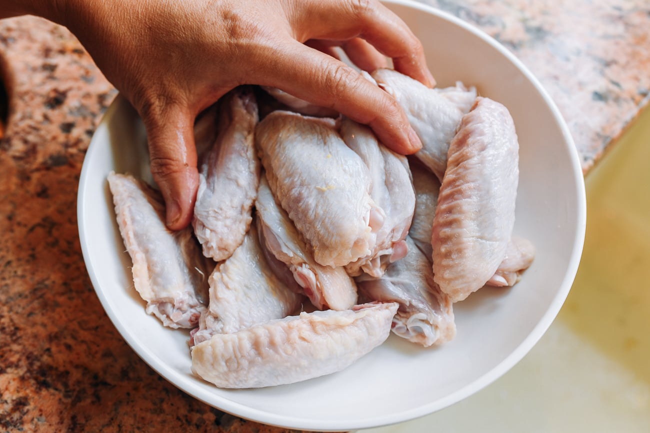 Tossing chicken wing flats with salt