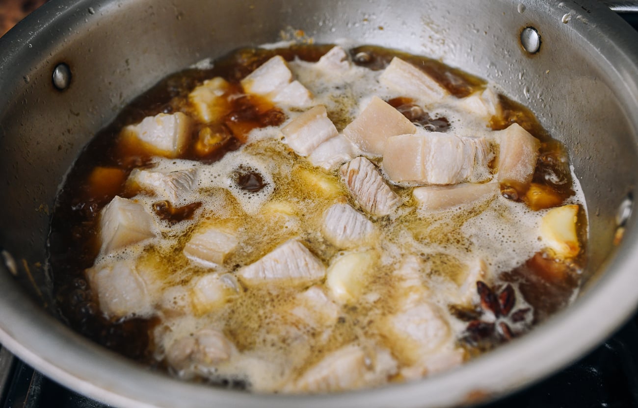 simmering pork belly in braising liquid