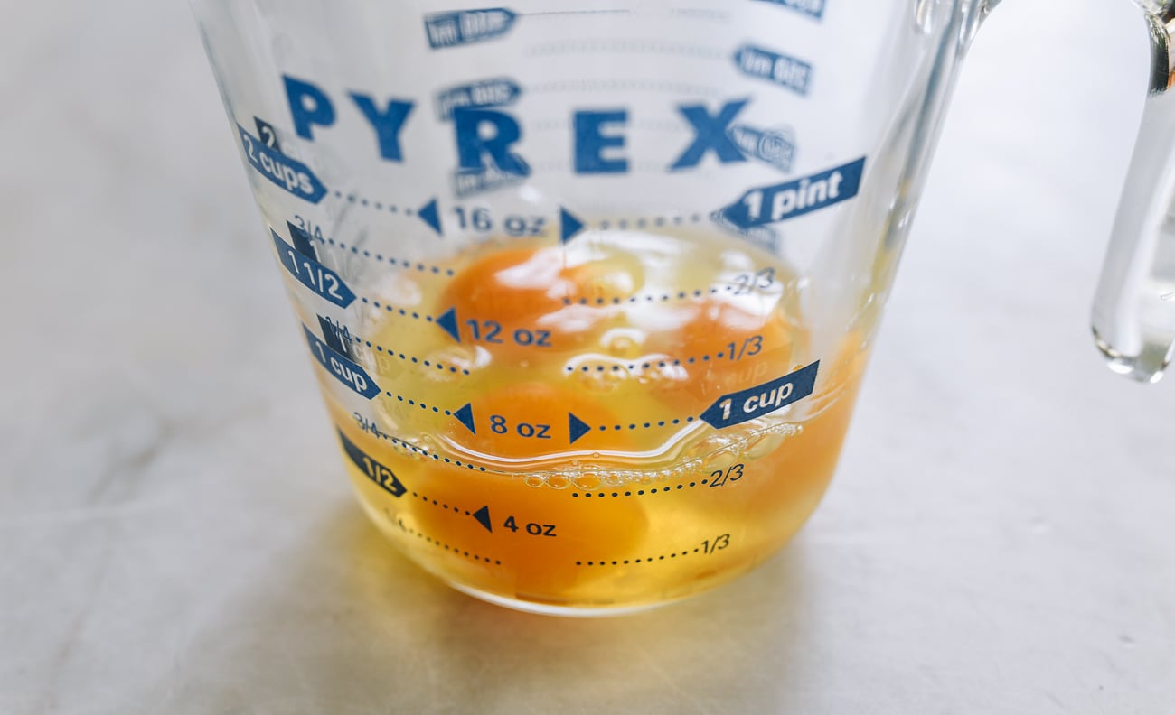 three eggs in measuring cup