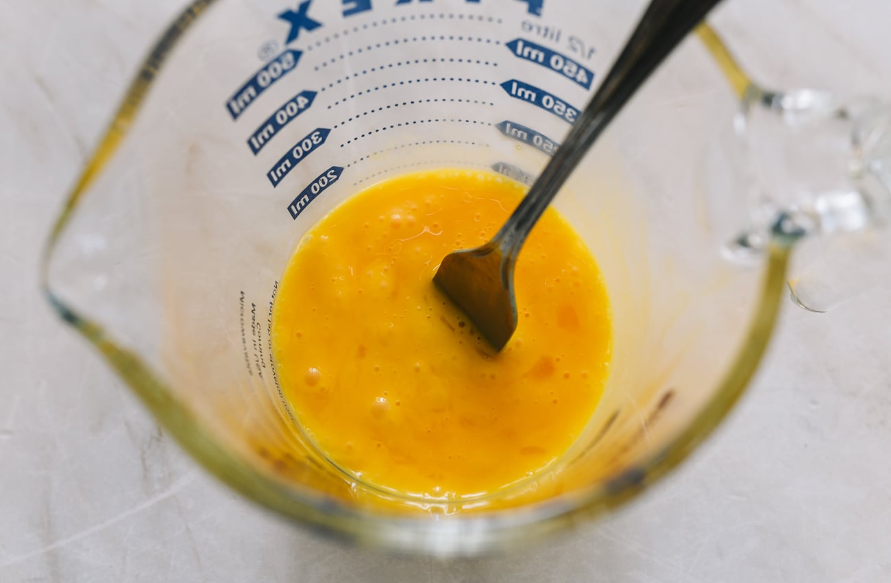 beating eggs in measuring cup