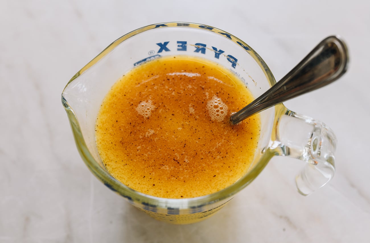 egg, water, and stock mixture in measuring cup